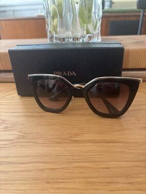 Prada Women’s Black and Gold Sunglasses